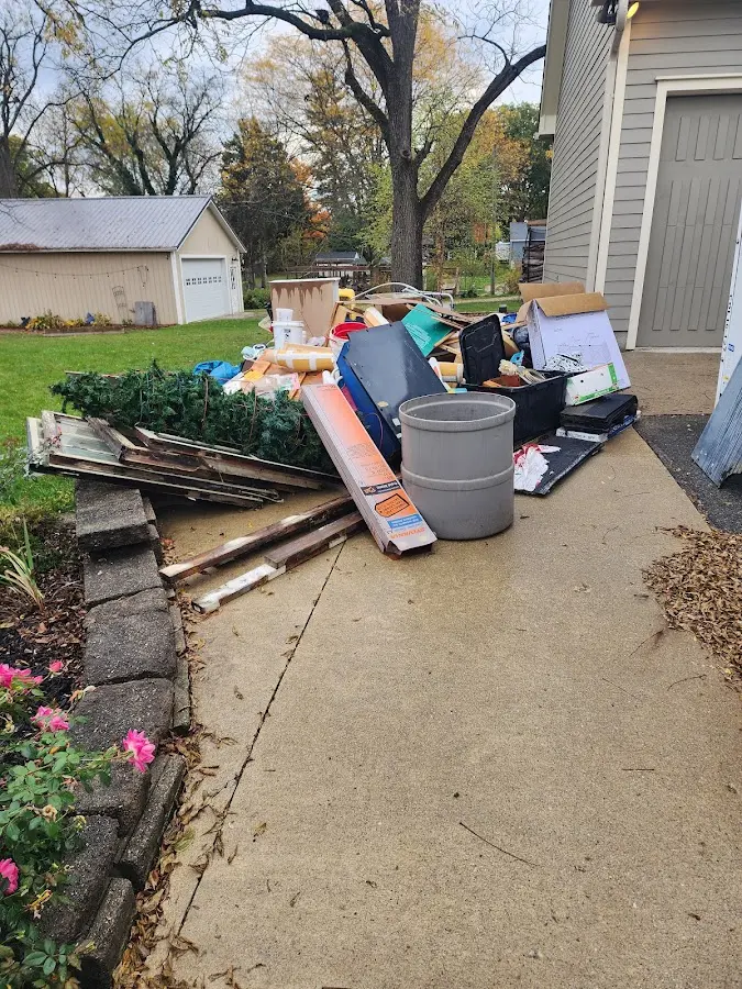 Dumpster being loaded with debris for 10 Yard Dumpster Rental in Medina